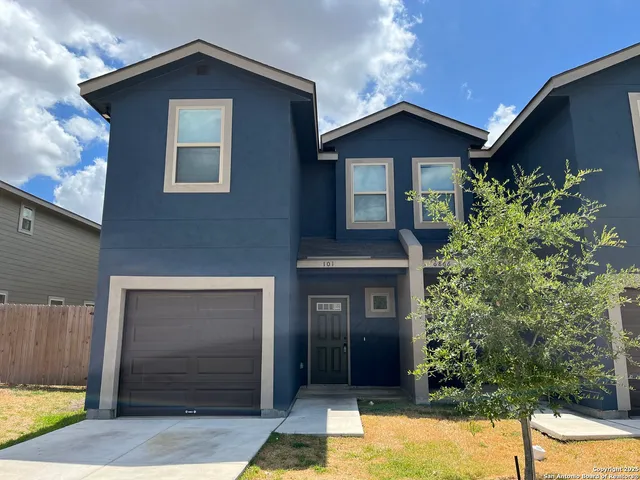 a front view of a house with garage