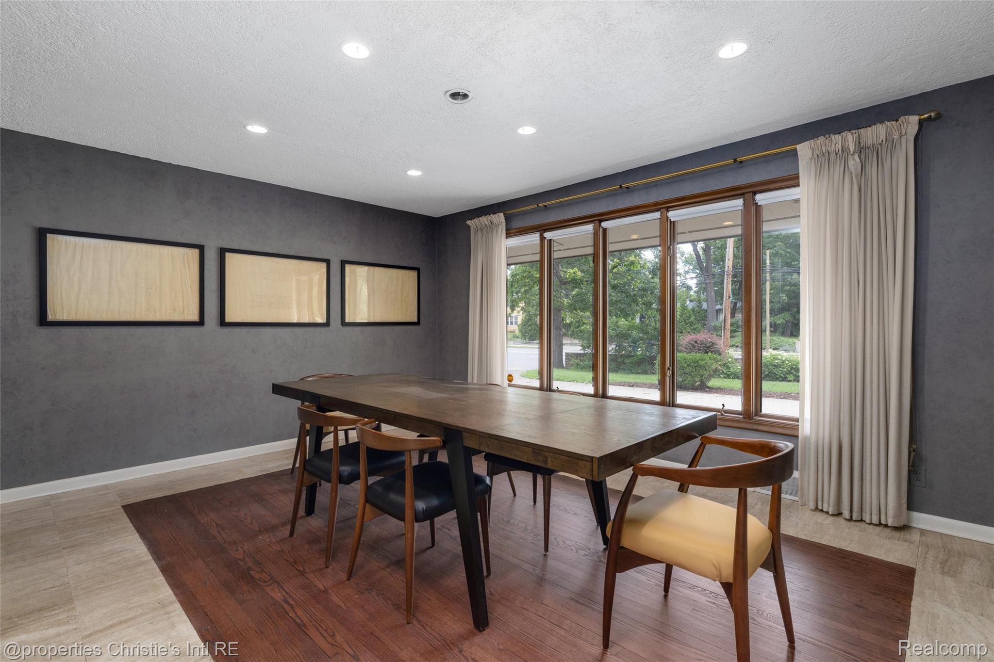 2771 West Seven Mile Road Detroit, MI 48221 - Photo 19 of 57 Spacious room featuring a wide window with natural wood framing, recessed ceiling lighting, and two distinct flooring materials