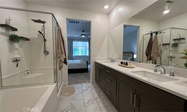 a en suite bathroom with a double sink shower and a mirror