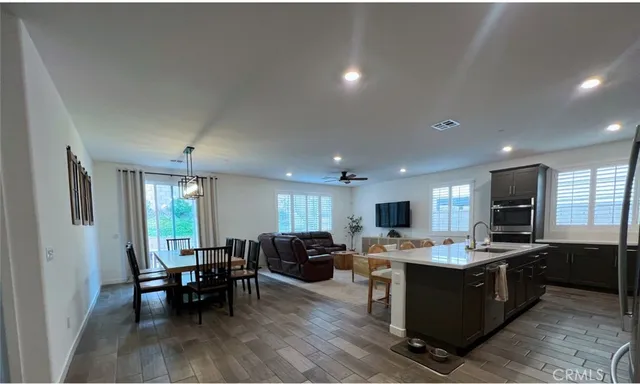 a living room with lots of furniture and kitchen view