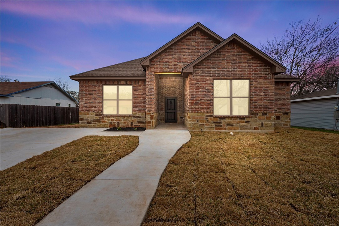a front view of a house with a yard