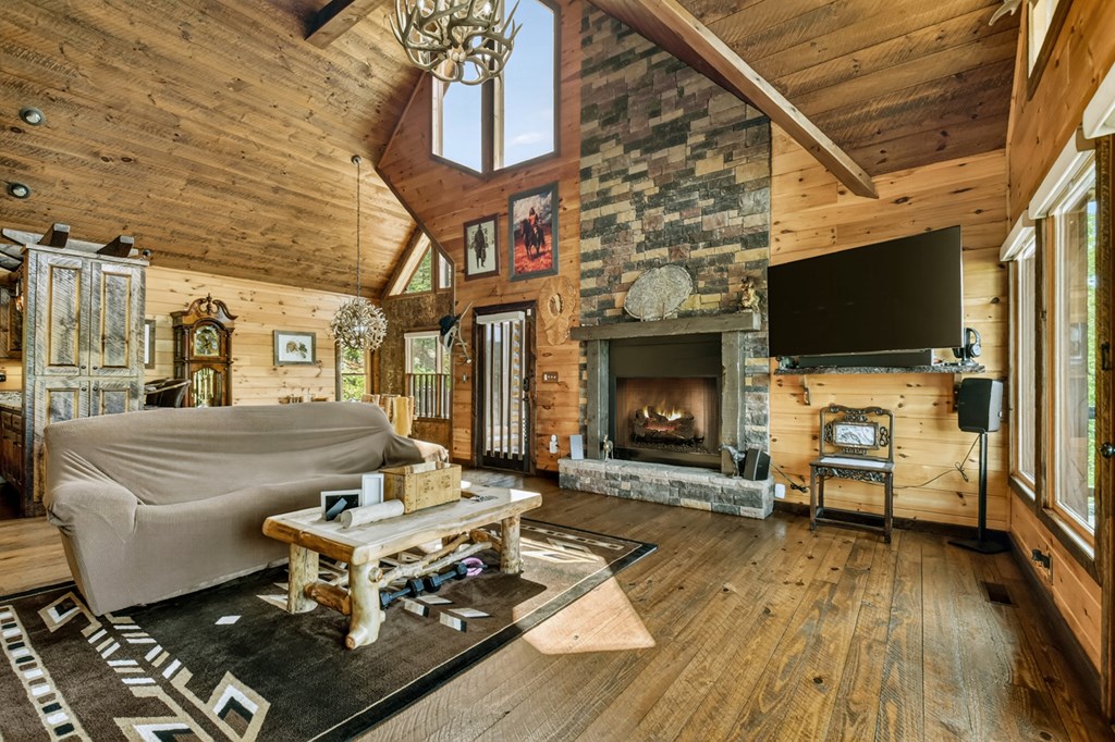 459 Quail Ridge Road Epworth, GA 30541 - Photo 10 of 73 a living room with furniture a flat screen tv and a fireplace