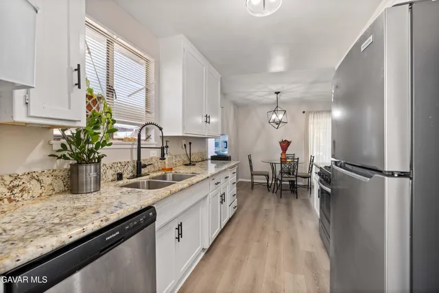 a kitchen with a sink appliances and cabinets
