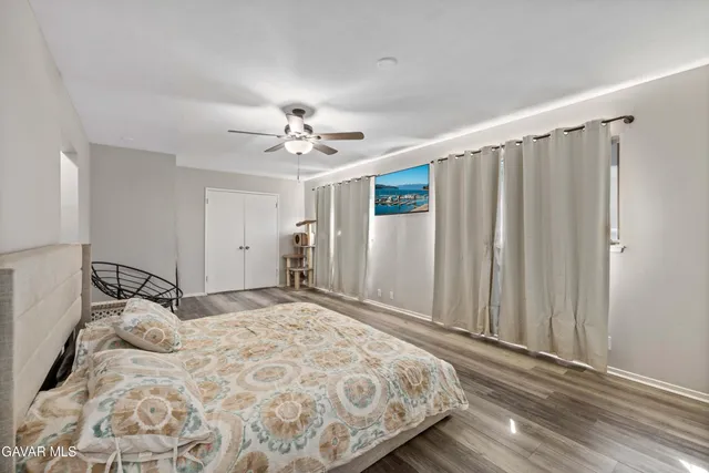 a bedroom with a large bed and a chandelier