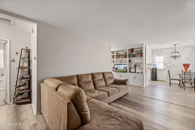 a living room with furniture and white walls