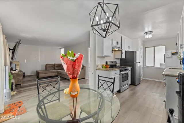 a kitchen with stainless steel appliances kitchen island granite countertop a stove a refrigerator and cabinets