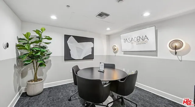 a dining room with furniture and potted plant