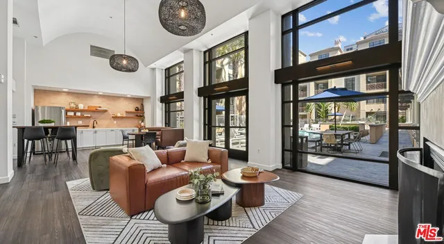 a living room with furniture a rug and a large window