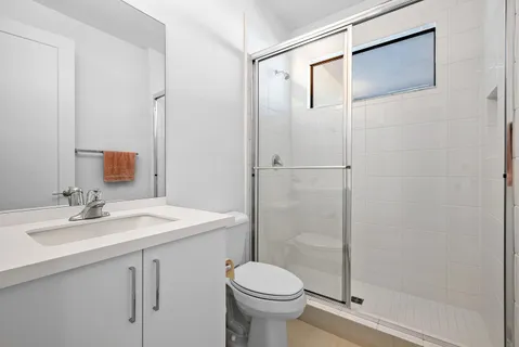 a bathroom with a sink toilet and shower