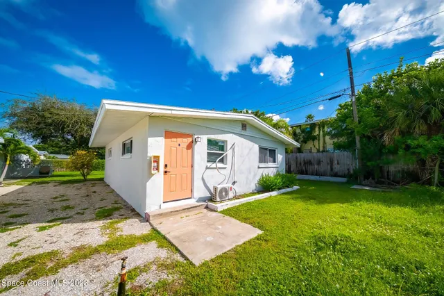 a view of a backyard with a large tree