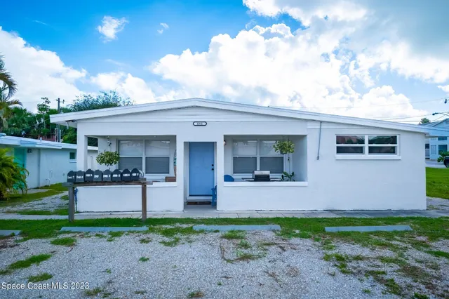 a view of a house with backyard and porch