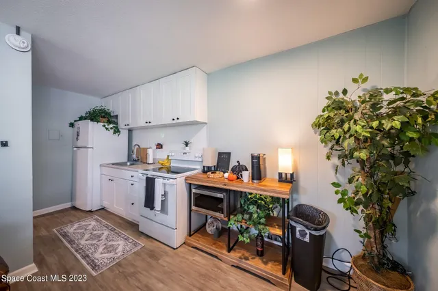 a open kitchen with stainless steel appliances granite countertop a refrigerator and a stove