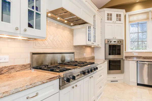 a kitchen with stainless steel appliances granite countertop a stove and a granite counter tops