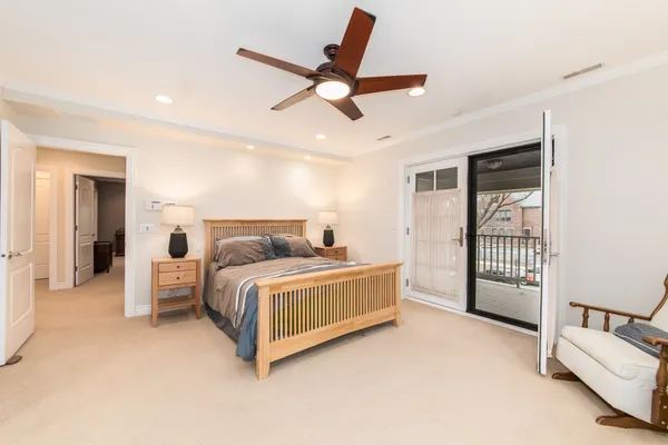 a bed room with a bed and a ceiling fan