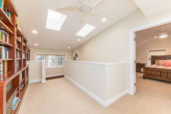 a bedroom with a bed and wall painting