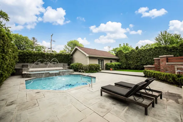 an aerial view of residential houses with outdoor space and parking