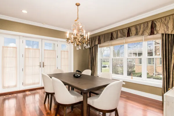 a view of a dining room with furniture wooden floor and chandelier