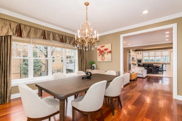 a view of a dining room with furniture wooden floor and chandelier