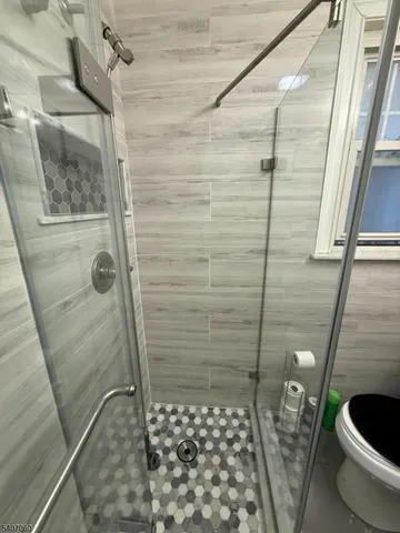 a bathroom with a toilet and shower
