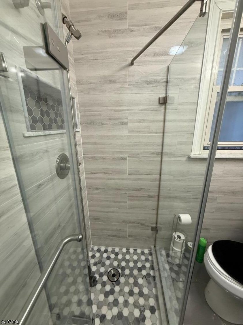 a bathroom with a toilet and shower