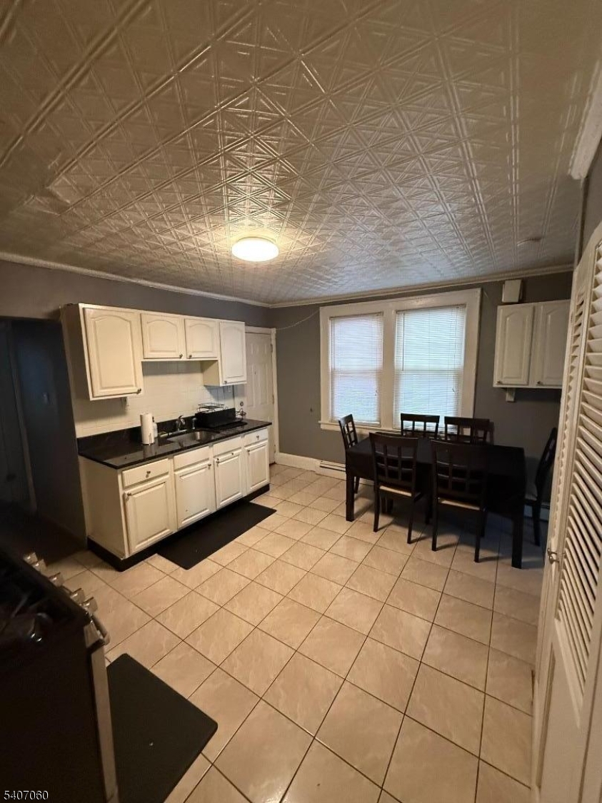 243 Lake Street Newark, NJ 07104 - Photo 12 of 16 a kitchen with stainless steel appliances kitchen island granite countertop a sink and a counter top space
