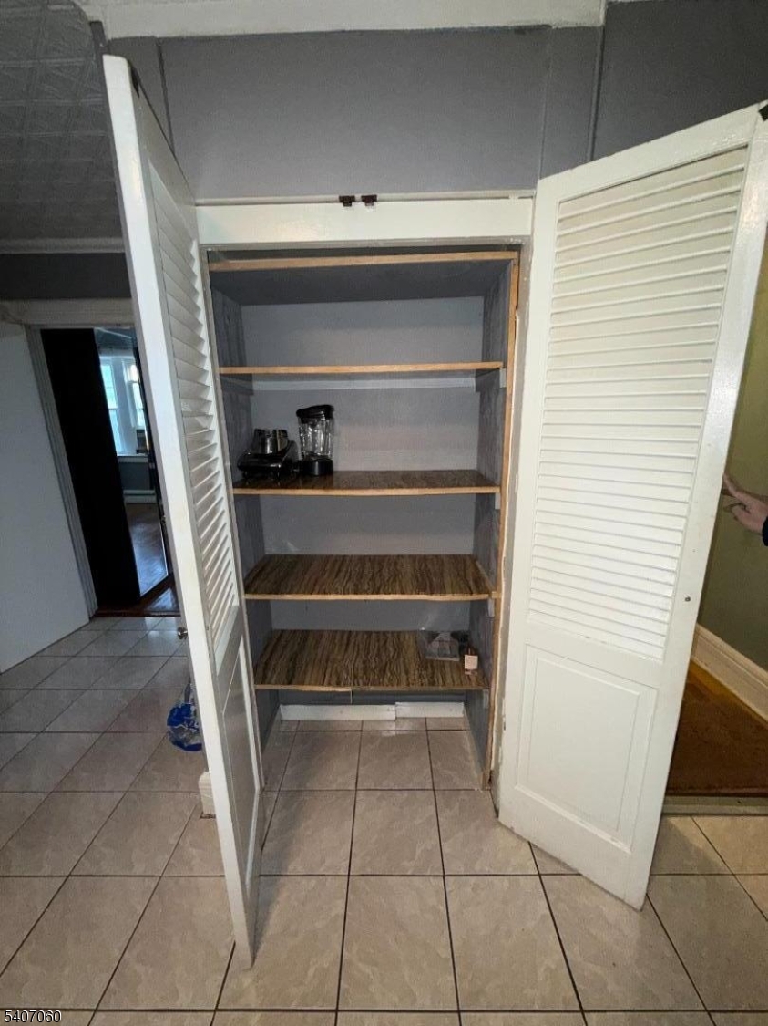 243 Lake Street Newark, NJ 07104 - Photo 14 of 16 a storage room with washer and dryer