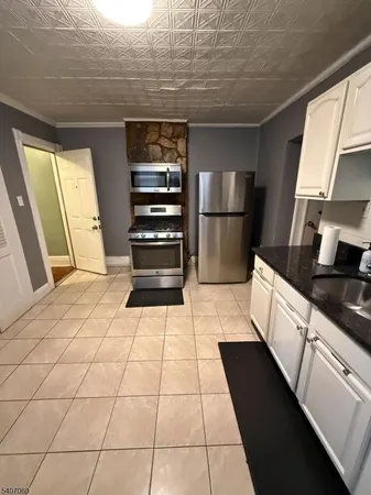a kitchen with a sink a stove and refrigerator