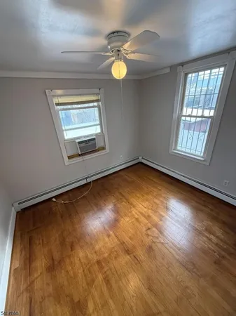 an empty room with windows and mirror