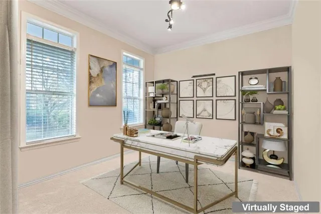 a view of a livingroom with workspace and a window