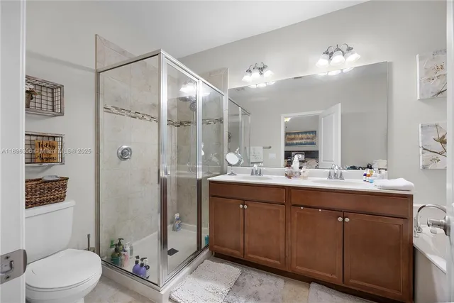 a bathroom with a sink vanity mirror and toilet