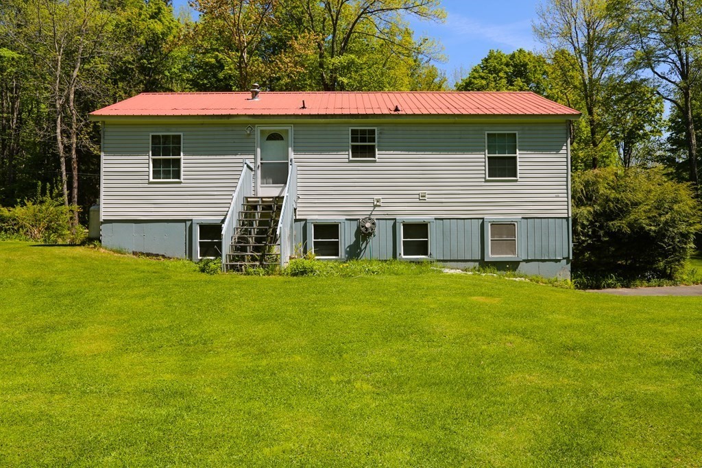 169 Ford Hill Road Rowe, MA 01367 - Photo 3 of 24 a front view of a house with a garden