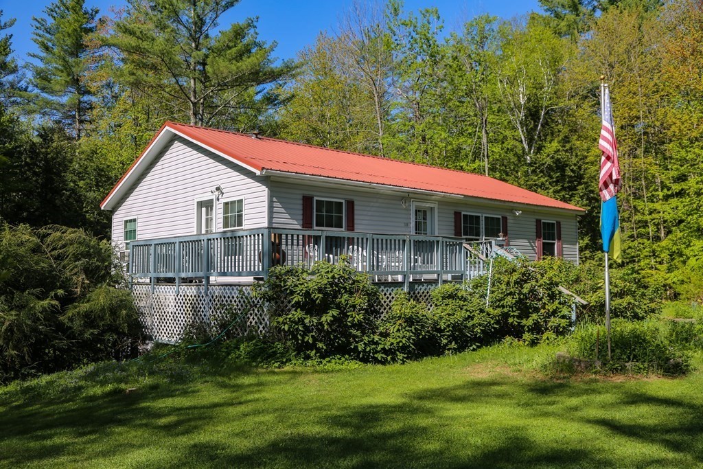 169 Ford Hill Road Rowe, MA 01367 - Photo 6 of 24 a house with a big yard and potted plants in front of it