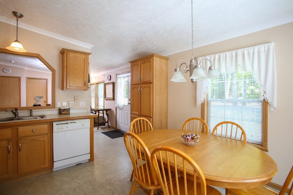 169 Ford Hill Road Rowe, MA 01367 - Photo 8 of 24 a open kitchen with stainless steel appliances granite countertop a stove a sink a dining table and chairs
