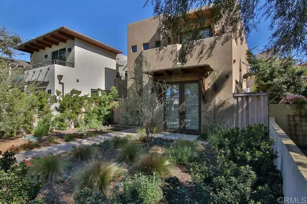 a view of a house with brick walls and plants