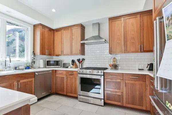 a kitchen with a stove sink and cabinets