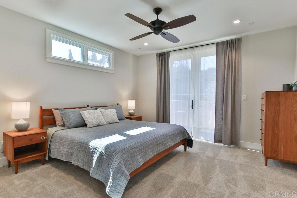 573 H Coronado, CA 92118 - Photo 28 of 39 a bedroom with a bed and a chandelier