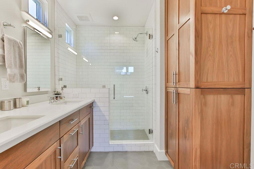 573 H Coronado, CA 92118 - Photo 30 of 39 a bathroom with a double vanity sink mirror and shower