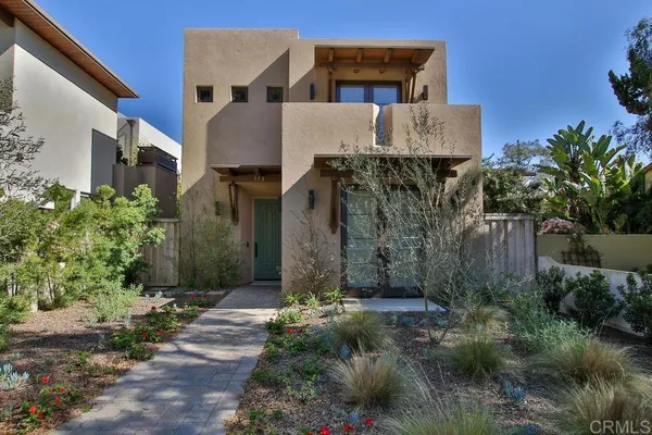 a front view of a house with a garden