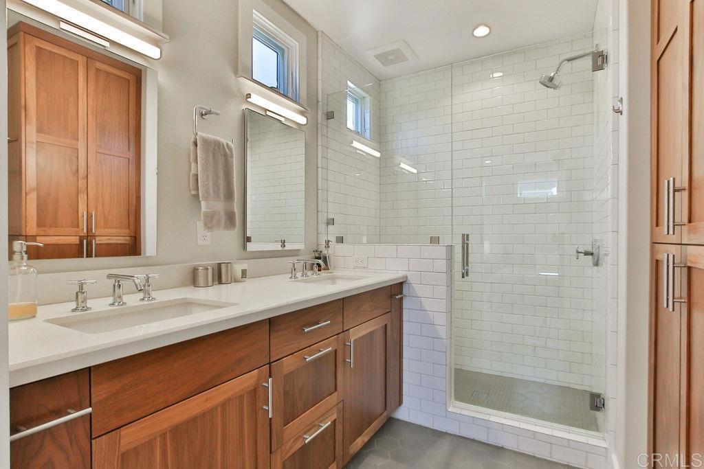 573 H Coronado, CA 92118 - Photo 31 of 39 a bathroom with a double vanity sink mirror and shower