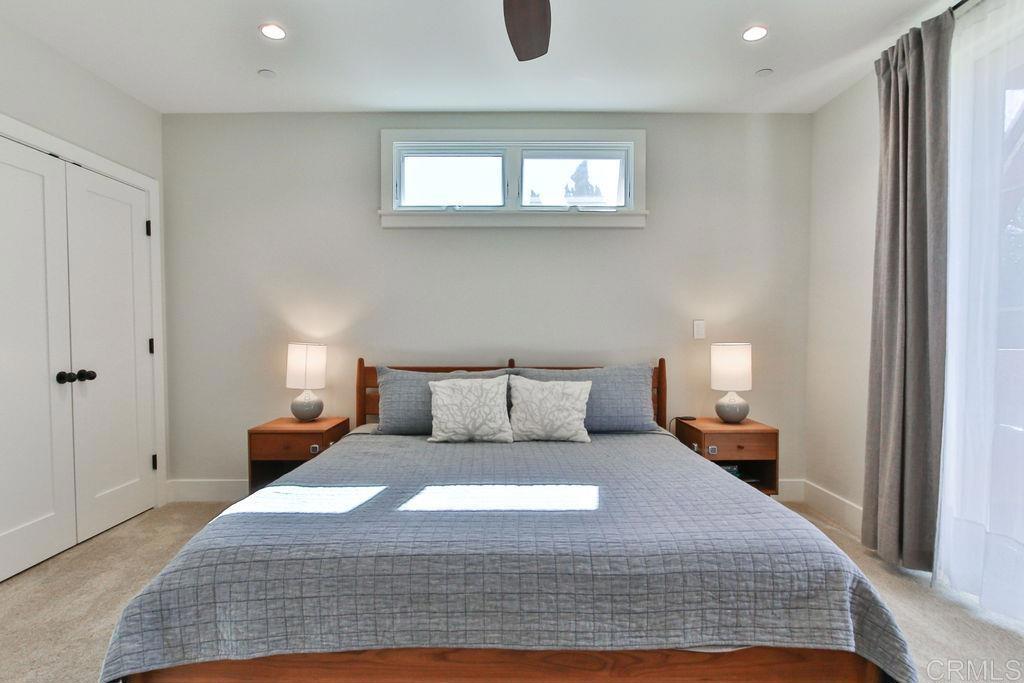 573 H Coronado, CA 92118 - Photo 32 of 39 a large bed sitting in a bedroom next to a window