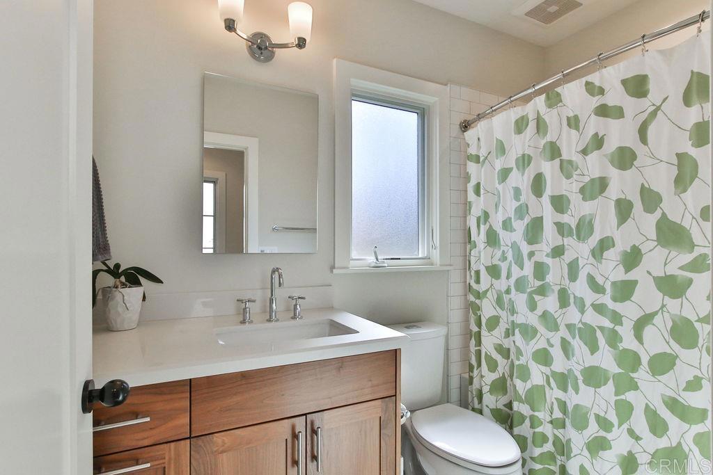 573 H Coronado, CA 92118 - Photo 37 of 39 a bathroom with a sink toilet and shower