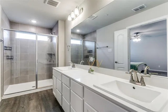 a bed sitting in a bedroom next to a window and a chandelier