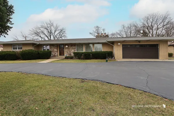 a front view of a house with a yard and a garage