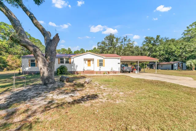 a view of a house with a yard