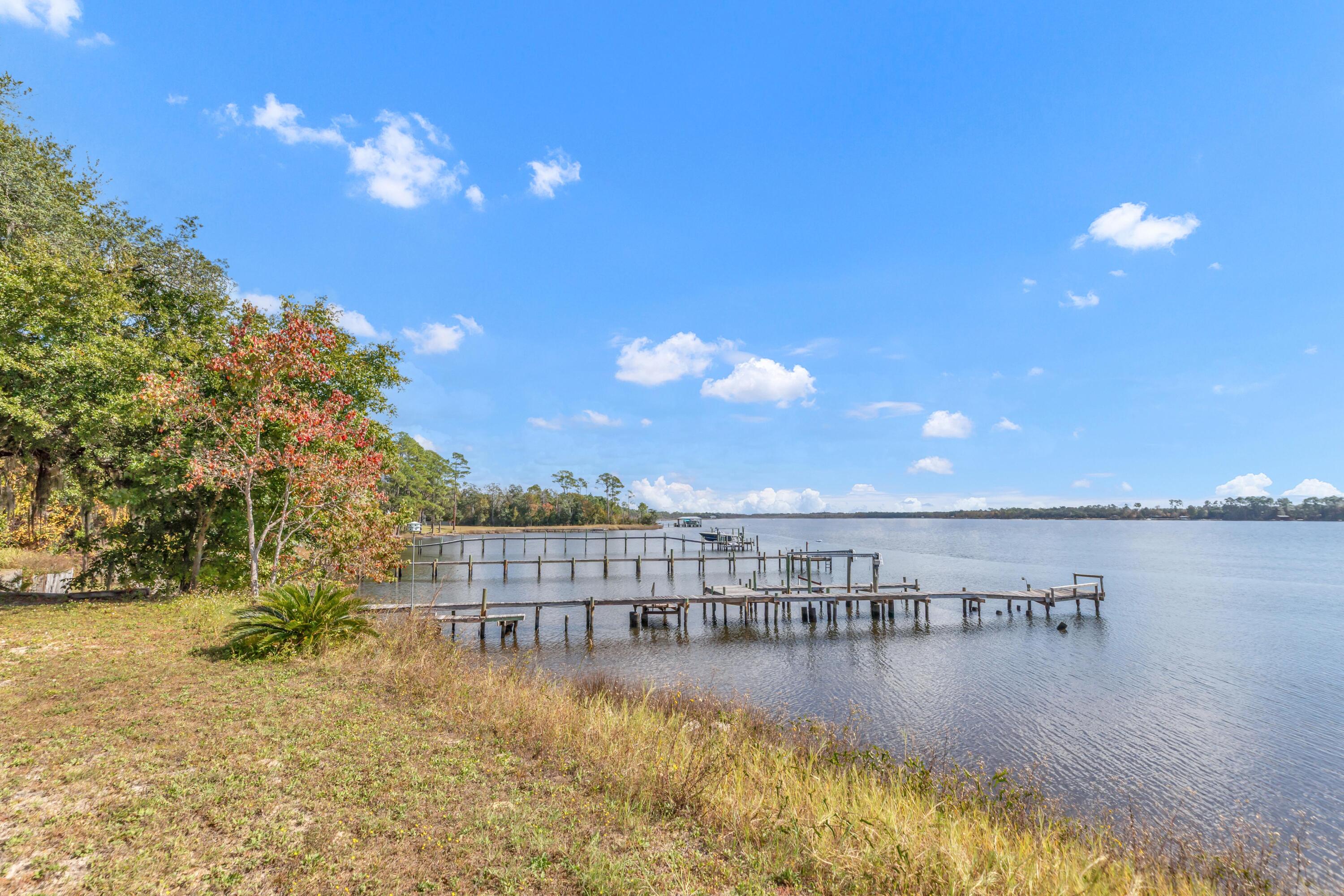 7478 Rose Street Navarre, FL 32566 - Photo 19 of 60 a view of a lake with outdoor space