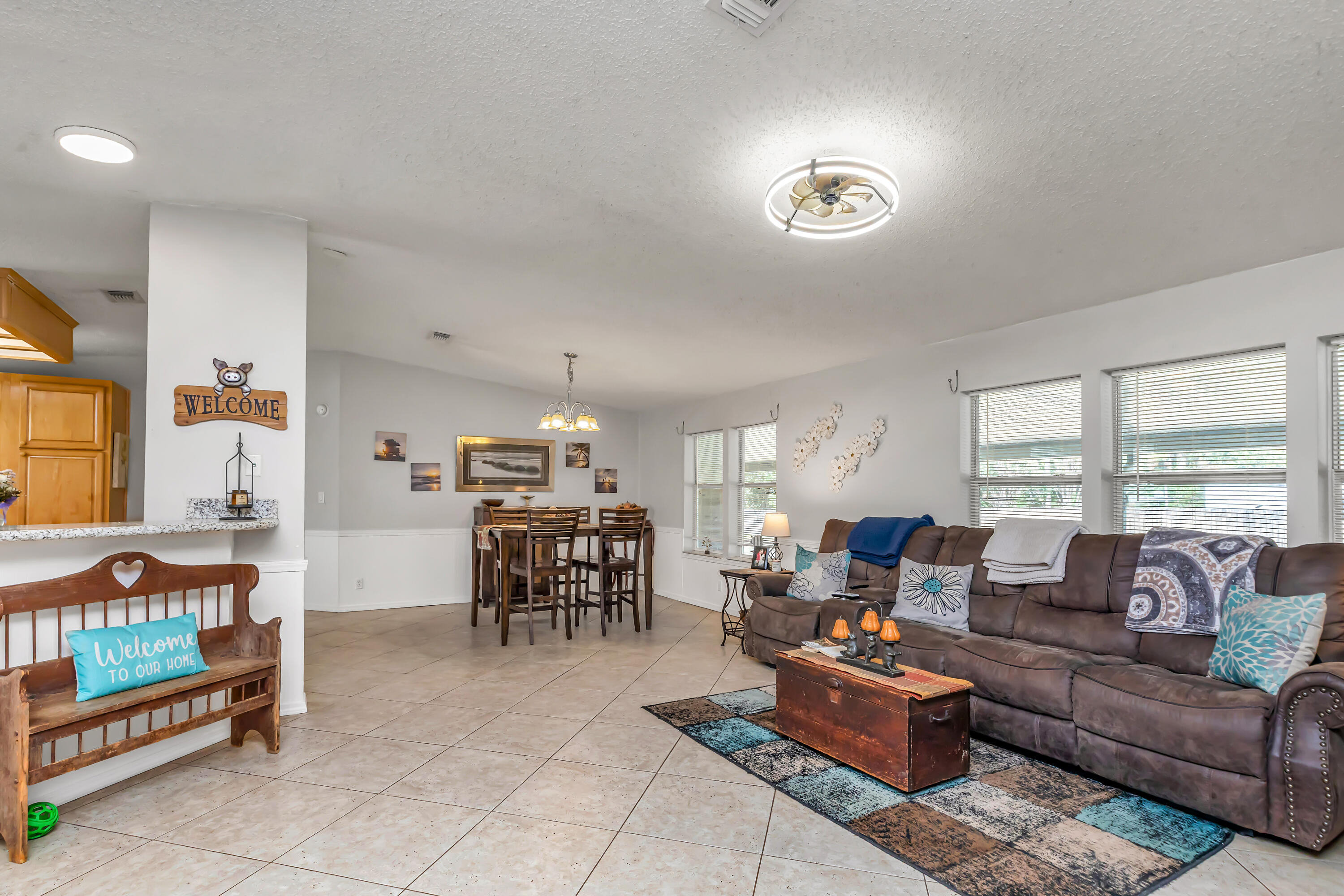 7478 Rose Street Navarre, FL 32566 - Photo 22 of 60 a living room with furniture and a table
