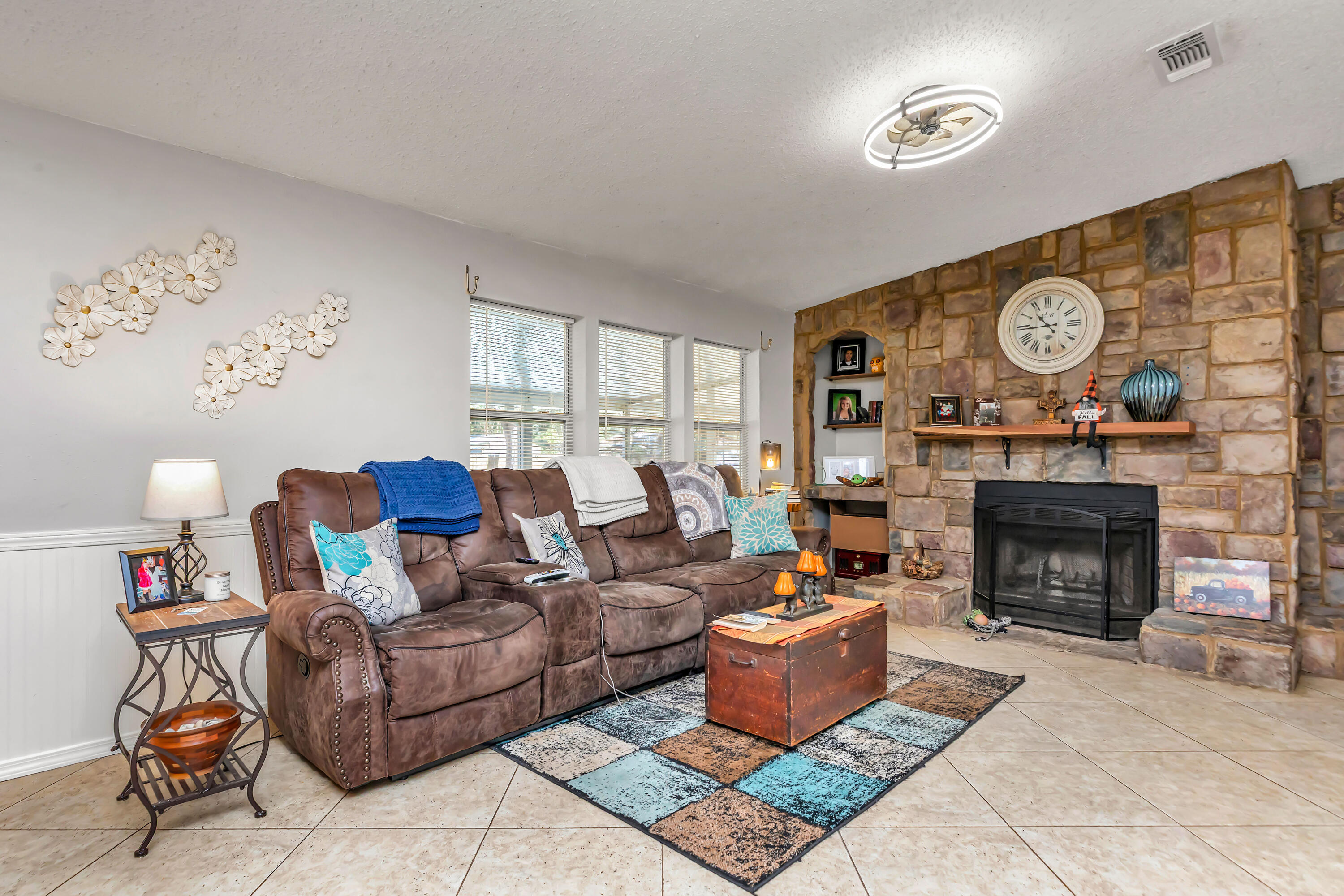 7478 Rose Street Navarre, FL 32566 - Photo 23 of 60 a living room with furniture a fireplace and a large window