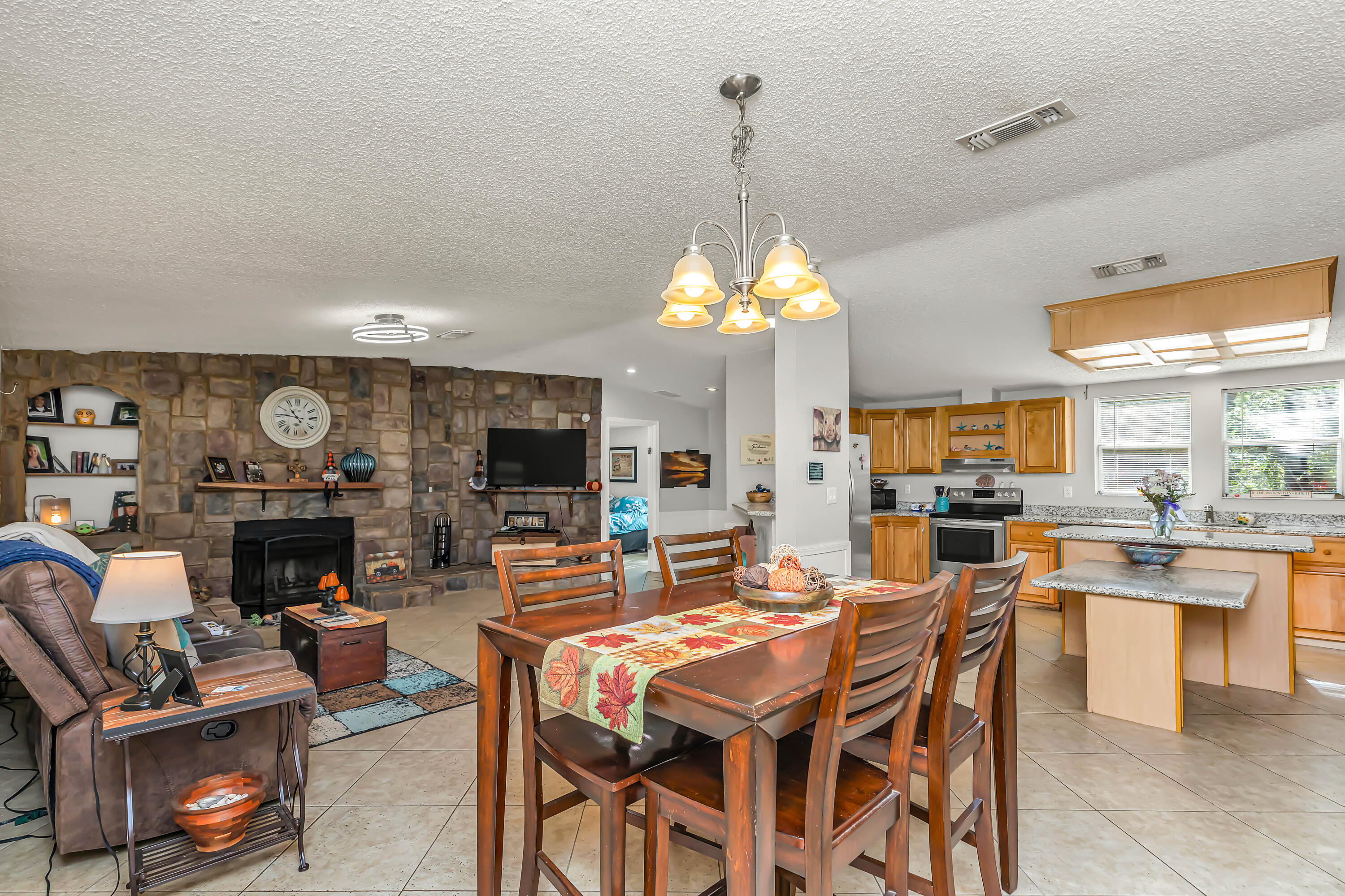 7478 Rose Street Navarre, FL 32566 - Photo 26 of 60 a view of a dining room with furniture window and wooden floor
