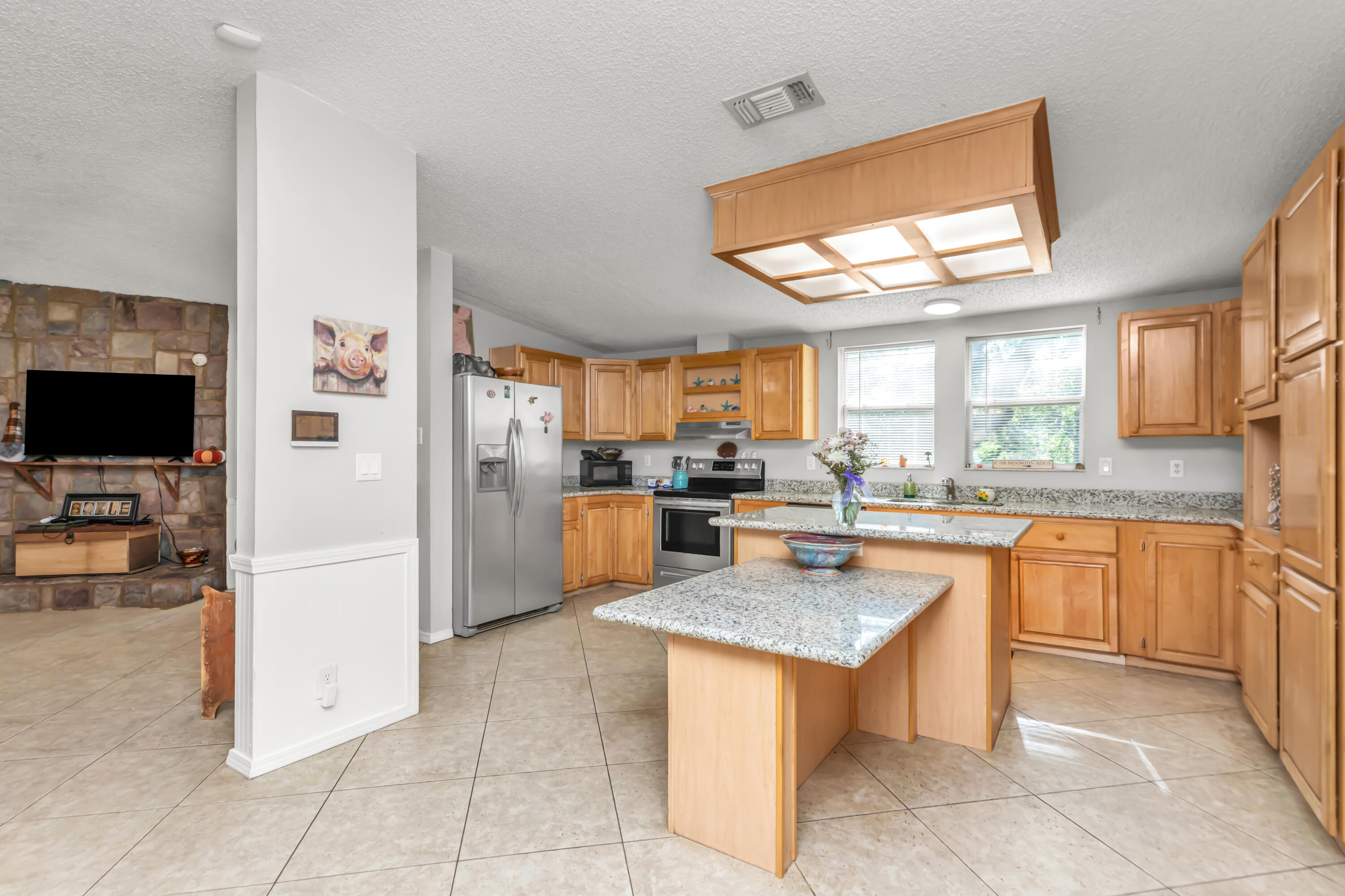 7478 Rose Street Navarre, FL 32566 - Photo 27 of 60 a kitchen with stainless steel appliances granite countertop a refrigerator a sink dishwasher stove and oven