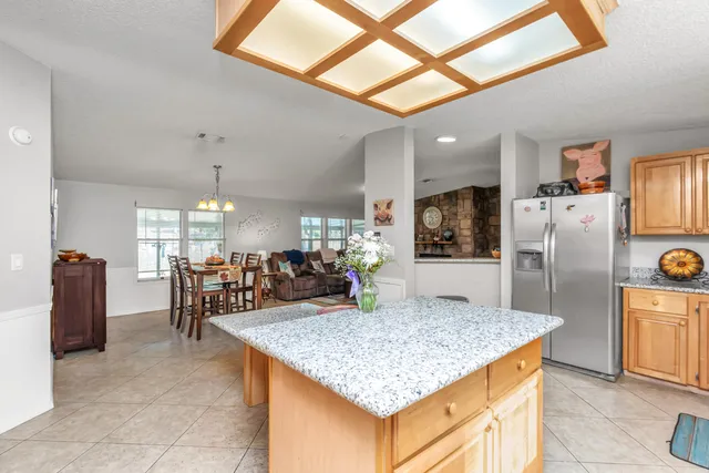a bedroom with a bed and a flat tv screen on dresser